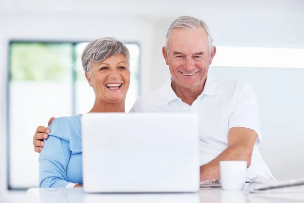 Happy Mature Couple Smiling While Using Laptop Home Stock Image