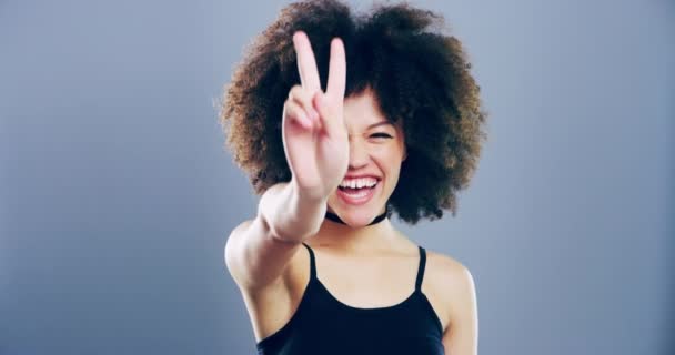 Video Footage Young Woman Showing Peace Sign Grey Background — Stockvideo