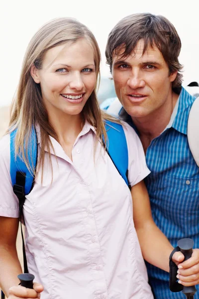 Portrait of cute couple with backpack ready for hiking.