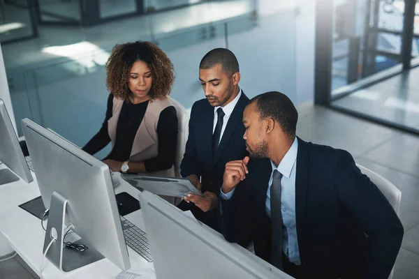 High Angle Shot Three Corporate Businesspeople Looking Some Paperwork Office — Stockfoto