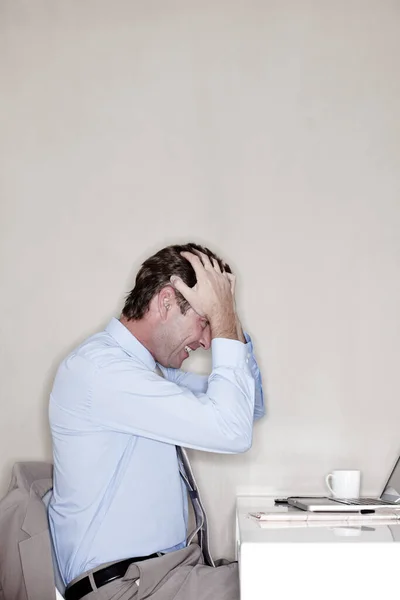 Mature Businessman Sitting His Desk His Hands His Hair Frustration — Foto Stock