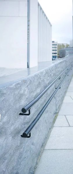 Closeup Metal Railing Alongside Grey Stone Wall City Macro View — 스톡 사진