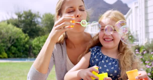 Video Footage Little Girl Her Mother Blowing Bubbles Together Outdoors — 图库视频影像