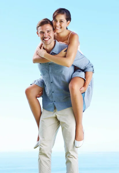 Portrait Young Couple Enjoying Piggyback Ride Together Outdoors — Stockfoto