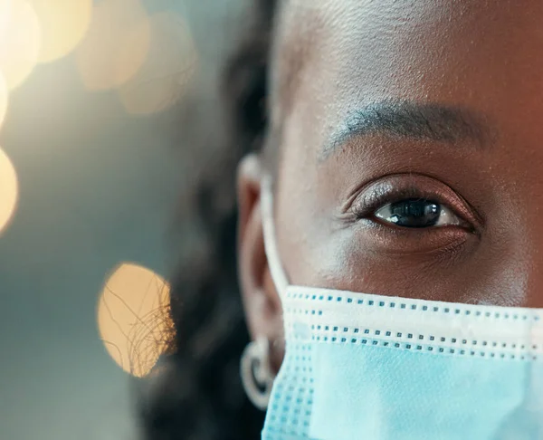 closeup face of medical doctor wearing mask. African american doctor wearing a corona mask. Half cropped face of young gp wearing a mask. Headshot of young specialist with a mask.