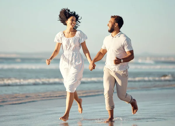 Happy Mixed Race Young Couple Holding Hands While Walking Beach — ストック写真