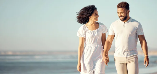 Happy Mixed Race Young Couple Holding Hands While Walking Beach — ストック写真