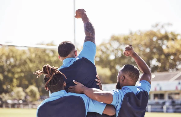 Diverse rugby teammates celebrating scoring a try or winning a match outside on a sports field. Rugby players cheering during a match after making a score. Teamwork ensures success and victory.