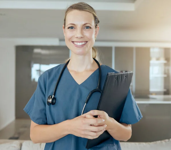 A beautiful young doctor looking happy and friendly while waiting at work. Smiling caucasian health care worker wearing a stethoscope and holding a folder.