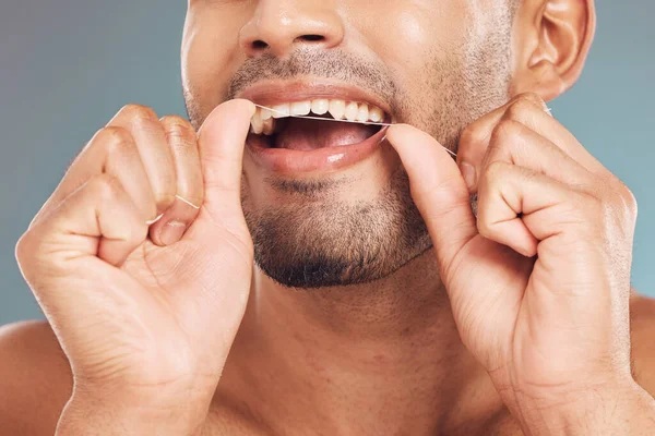 Closeup One Mixed Race Man Flossing His Teeth Blue Studio — Stock Photo, Image