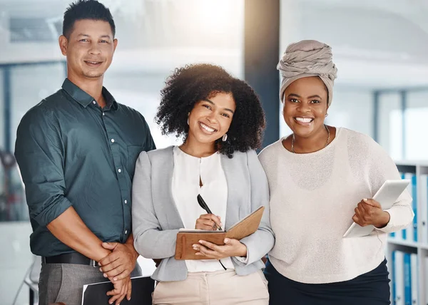 Portrait of a group of confident diverse businesspeople standing in an office. Happy smiling colleagues motivated and dedicated to success. Cheerful and ambitious team working closely together.