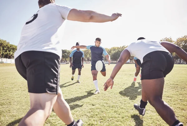 Mixed race rugby player attempting a dropkick during a rugby match outside on the field. Hispanic man kicking for touch or attempting to score three points during a game. Getting his team up the field