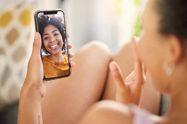 a young woman on a video call while relaxing at home.