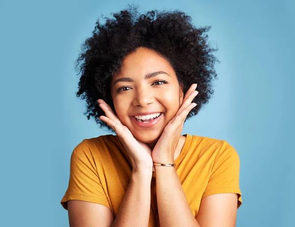 Attractive Young Woman Standing Alone Blue Background Studio Feeling Playful — Stockfoto