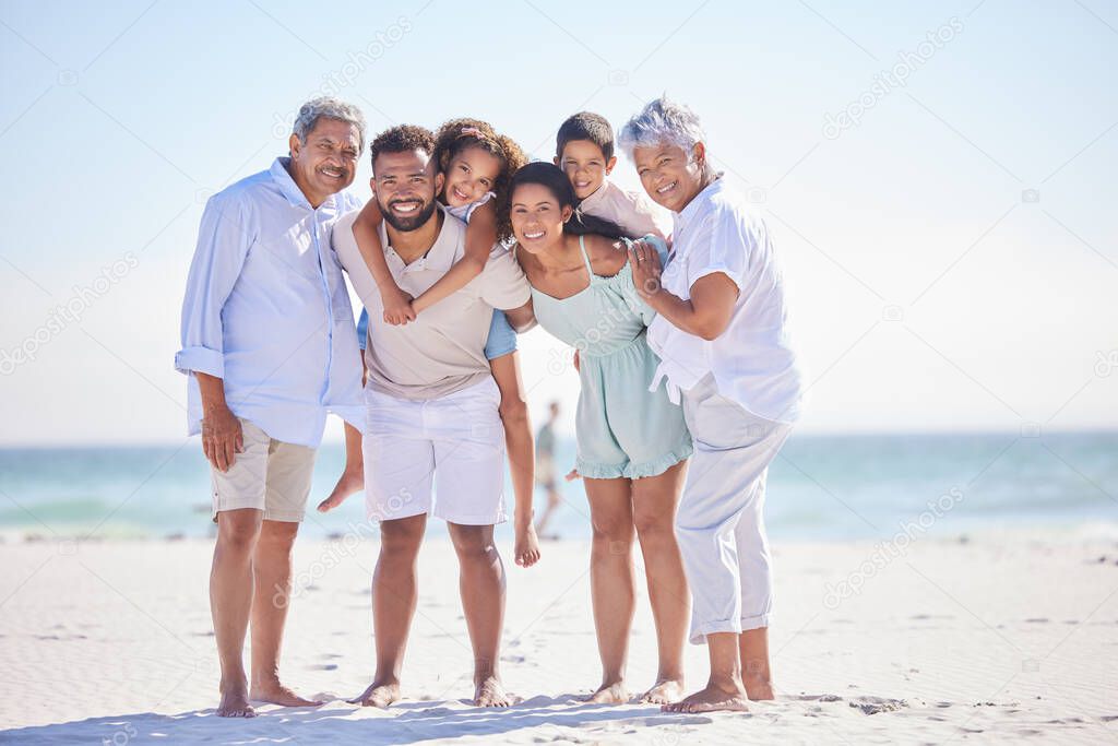 Three generation family on vacation standing together at the beach. Mixed race family with two children, two parents and grandparents spending time together by the sea.