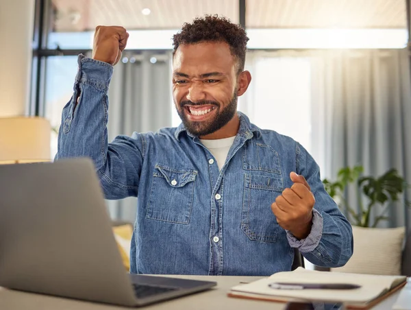 Excited businessman cheering for his success. Cheerful entrepreneur cheering after reading an email on his laptop. Virtual remote businessman in luck after using his computer.