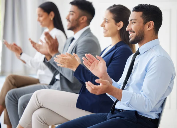 Group of diverse businesspeople clapping and celebrating success during interview. Team of applicants together, attending office seminar. Candidates in line for job opening, vacancy and opportunity.