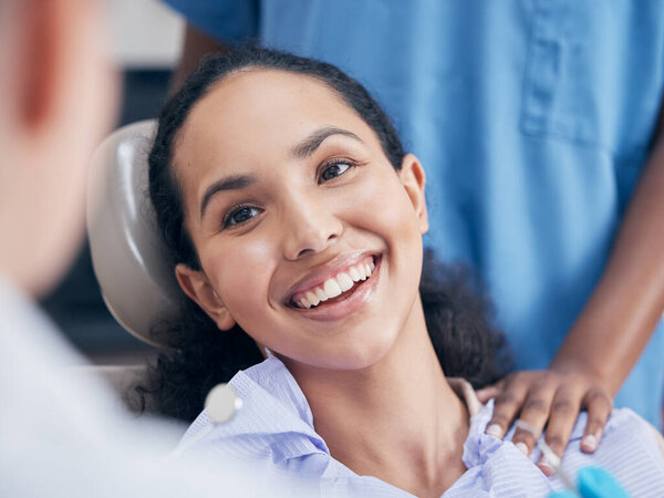 a young woman visiting her dentist for a checkup.