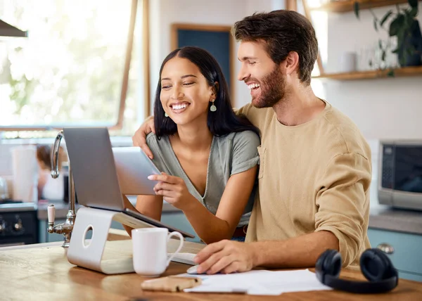 Happy Young Interracial Couple Calculating Budget Using Wireless Devices Home — Φωτογραφία Αρχείου