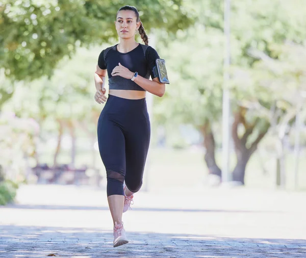 Sporty Young Female Athlete Wearing Phone Armband While Jogging Park —  Fotos de Stock