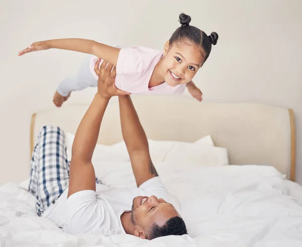 Joyful Young Father Lying Bed Lifting Excited Happy Little Child — Stockfoto