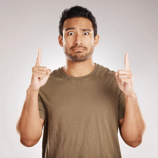 Handsome Young Mixed Race Man Pointing Copyspace While Standing Studio — Foto de Stock