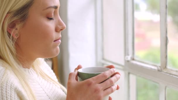 Sad Woman Drinking Tea While Looking Out Window Nostalgic Female — стоковое видео