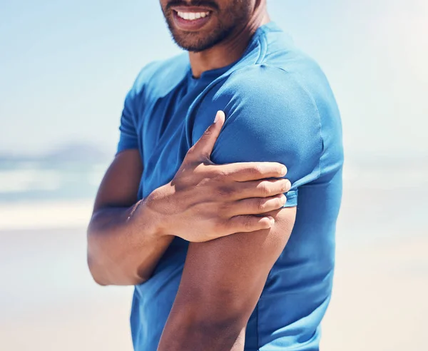 a man experiencing discomfort in his arm while out for a workout.