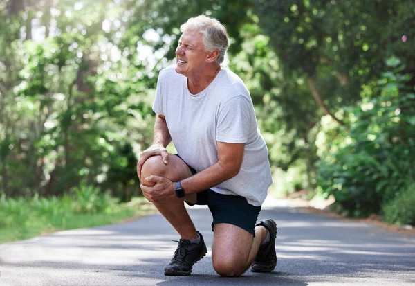 Mature Man Experiencing Knee Pain While Exercising Outdoors — Stock Photo, Image