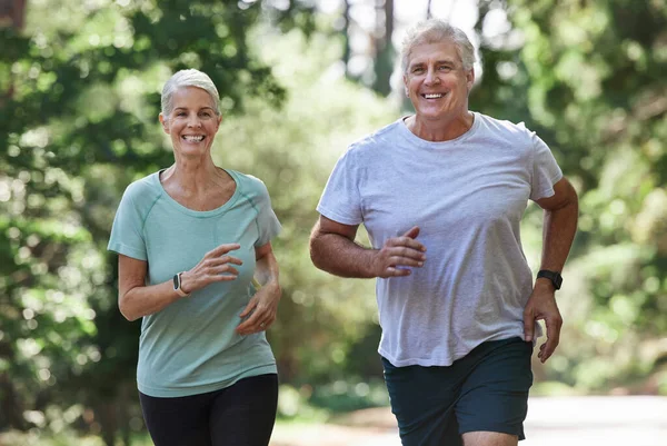 Mature Couple Running Together Outdoors — Foto de Stock