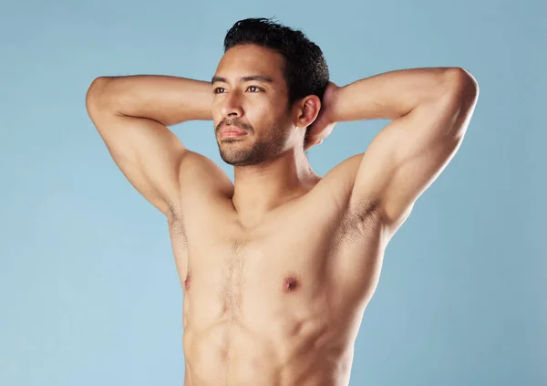 Handsome Young Hispanic Man Standing Shirtless Studio Isolated Blue Background — Stockfoto