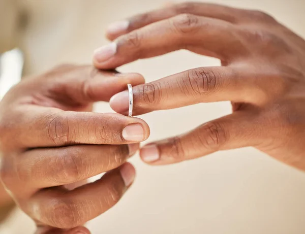 Man removing wedding band. Male hands taking off ring before going out to cheat. Finalising divorce.