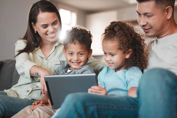 a young family using a digital tablet together at home.