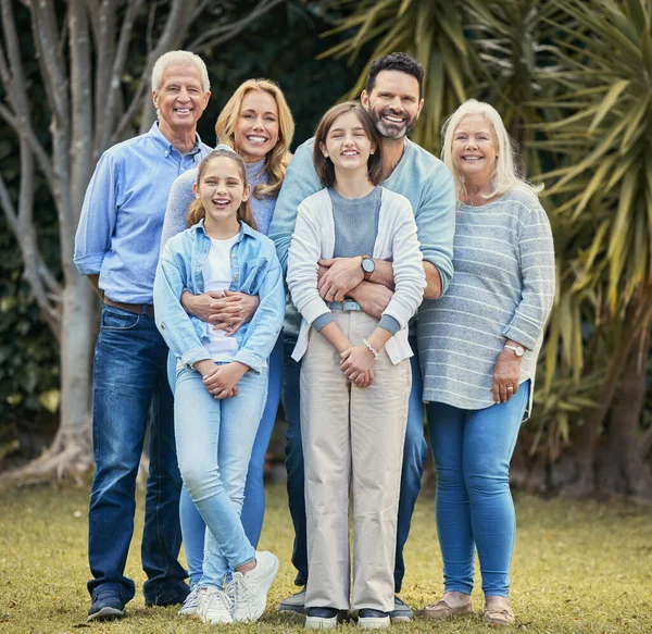 a multi-generational family standing together outside.