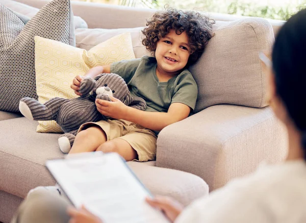 Do you love your new home. a little boy sitting with his teddybear during a consultation with a physiotherapist