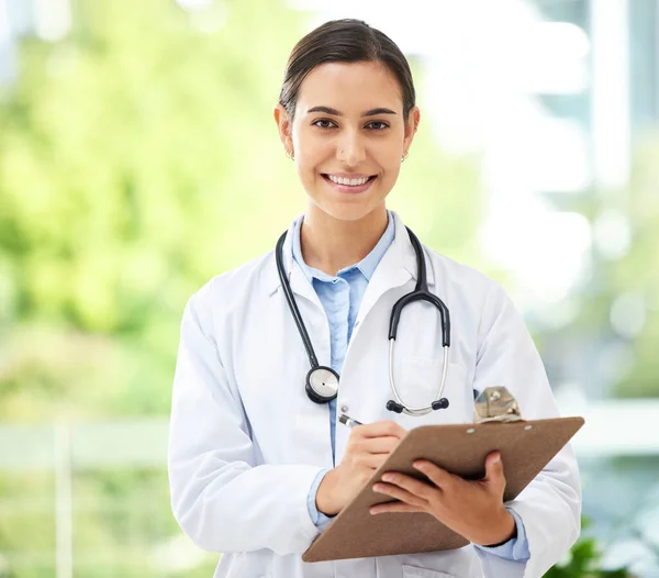 Confident Young Mixed Race Female Doctor Standing Clipboard Medical Office —  Fotos de Stock