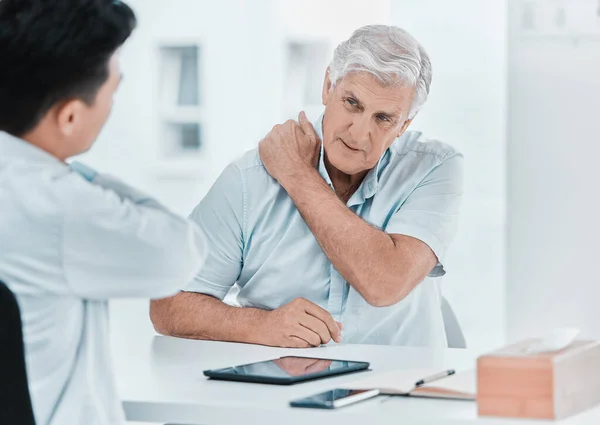 Yup Right Here Mature Man Sitting His Doctor Complaining Sore — Photo