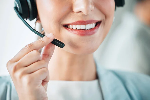 Closeup shot of an unrecognisable businesswoman wearing a headset while working in a call centre.