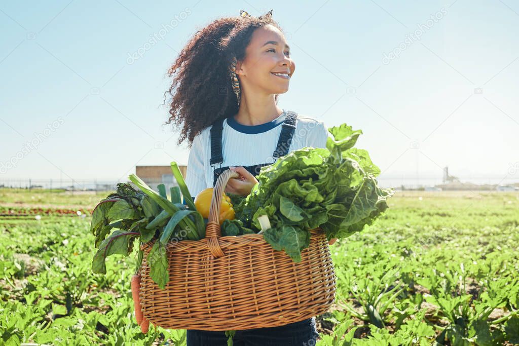 a young farmer holding a basket of freshly harvested veggies.