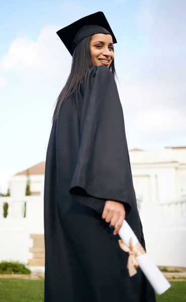 Have faith in the path set out for you. Portrait of a young woman holding her diploma on graduation day