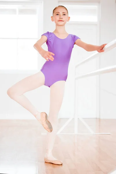 Blurred lines between work and play is how you win. a little girl practicing ballet in a dance studio