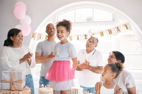 A birth-date is a reminder to celebrate life. a little girl enjoying a birthday party with her family at home