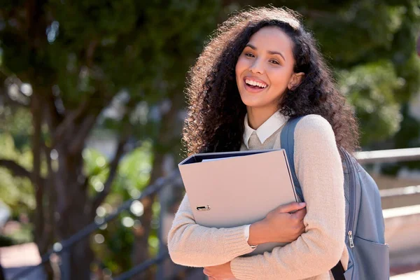 Destined for bigger things. Portrait of an attractive young female student standing outside on campus