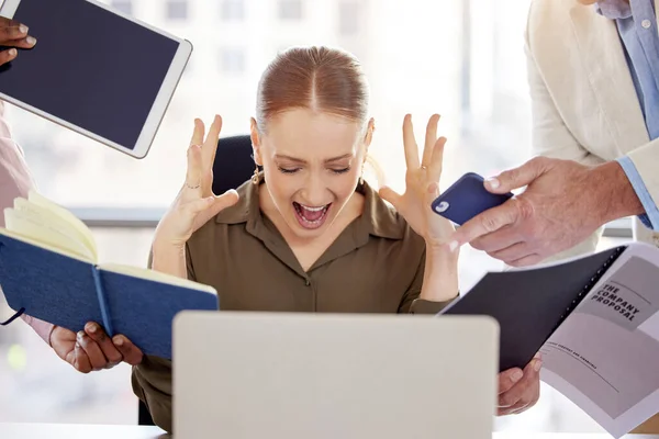 Can you all just leave me alone. an attractive young businesswoman sitting in her office and feeling frustrated while her colleagues put pressure on her