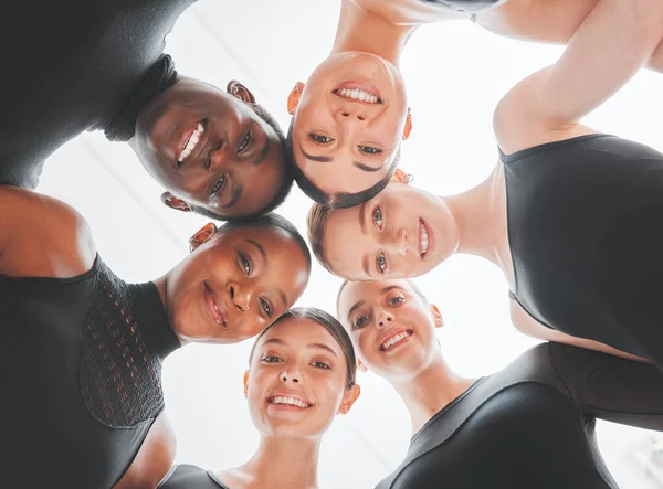 Hold on to your seats because were going to blow you away. a group of ballet dancers standing together in a huddle