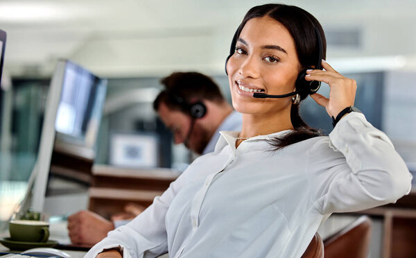 Ready to make your day. a young businesswoman working in a call center