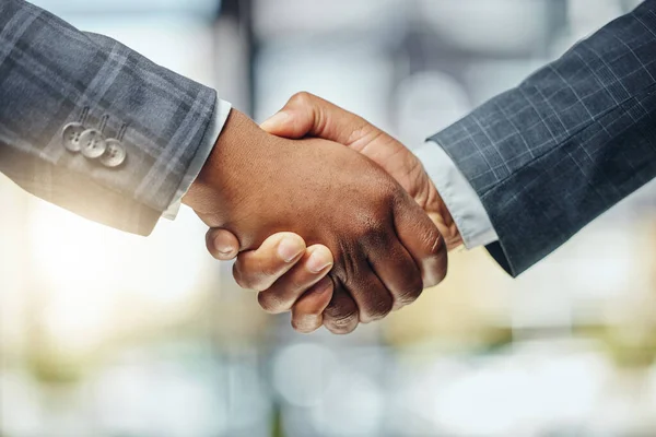 Shake my hand. two unrecognizable lawyers shaking hands at work