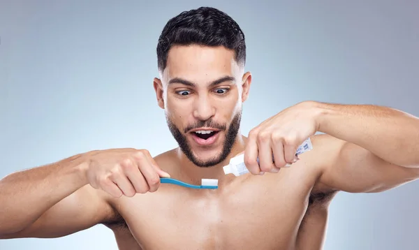 Young Man Squeezing Toothpaste Toothbrush Studio Background — Foto de Stock