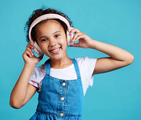 Adorable Little Girl Wearing Headphones While Standing Blue Background — Foto de Stock
