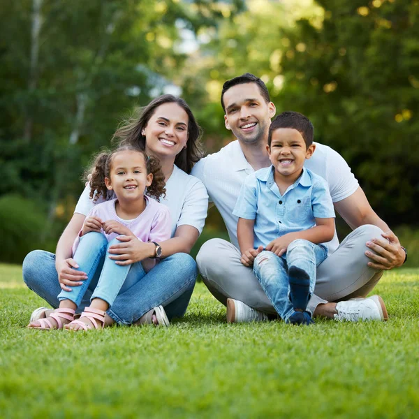 Young Happy Mixed Race Family Relaxing Sitting Grass Park Together — Stockfoto